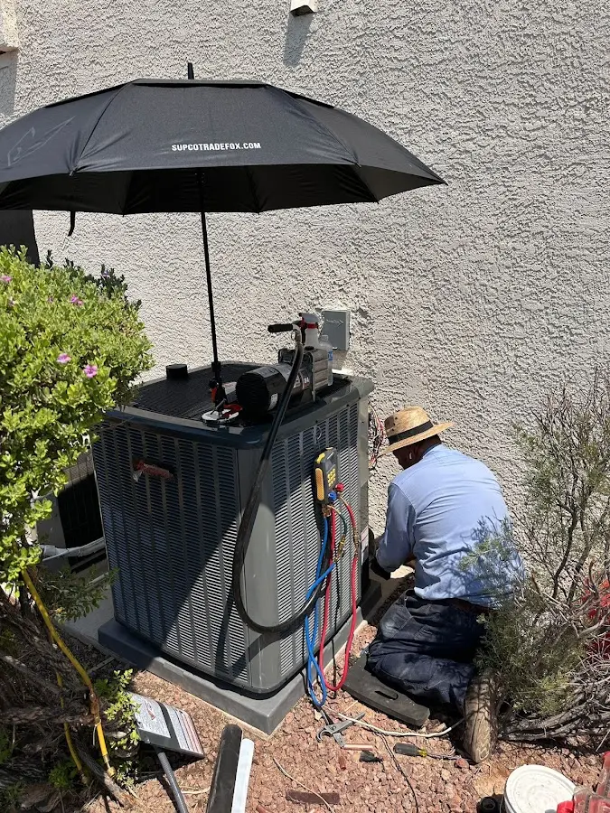 HVAC technician performing outdoor AC maintenance in Shirley